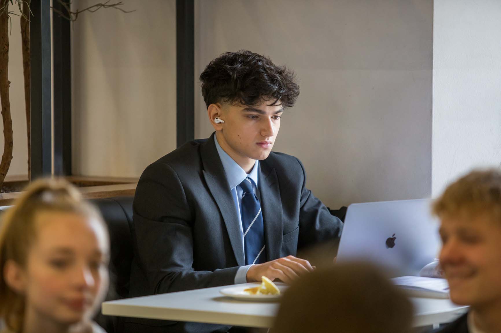 sixth form student working on a laptop